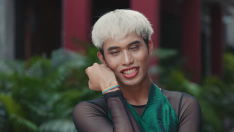 portrait of a happy person wearing lgbtq+ pride colors.