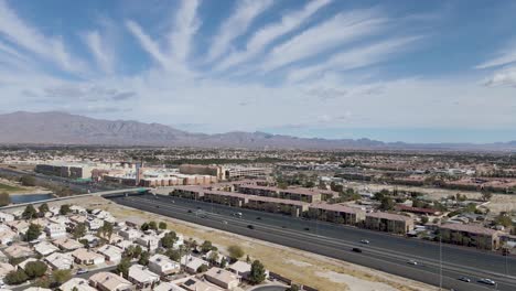 aerial view of summerlin area with mountains in background and sky with striped clouds, las vegas