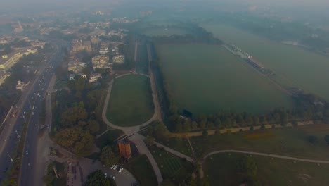 bombay, india, aerial view over the highway in foggy weather, traffic is going on, horse riding ground and trraining areas