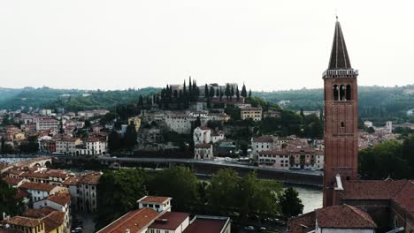 Drone-shot-pulling-away-from-the-Arno-River-in-Verona,-Italy