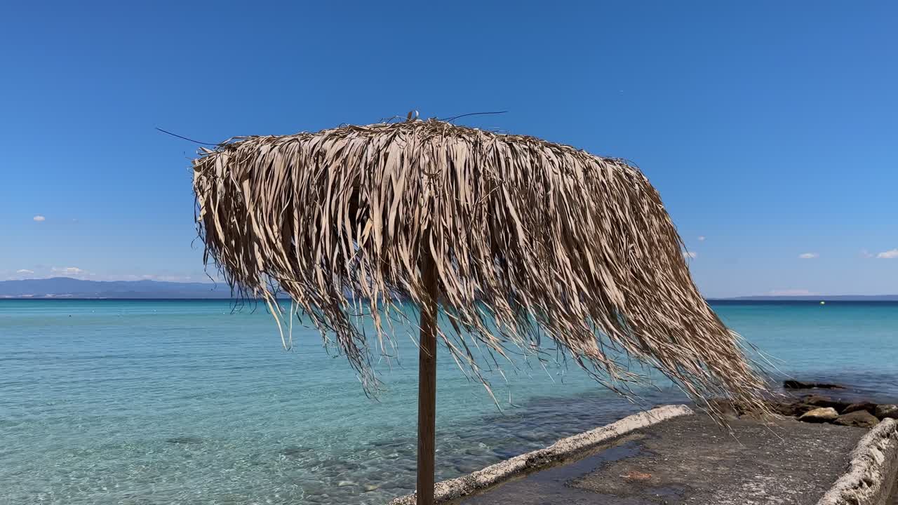 Stunning beach scene in Halkidiki, Greece, with elegant sunbeds facing the crystal-clear turquoise sea. A perfect summer escape in the heart of the Aegean.