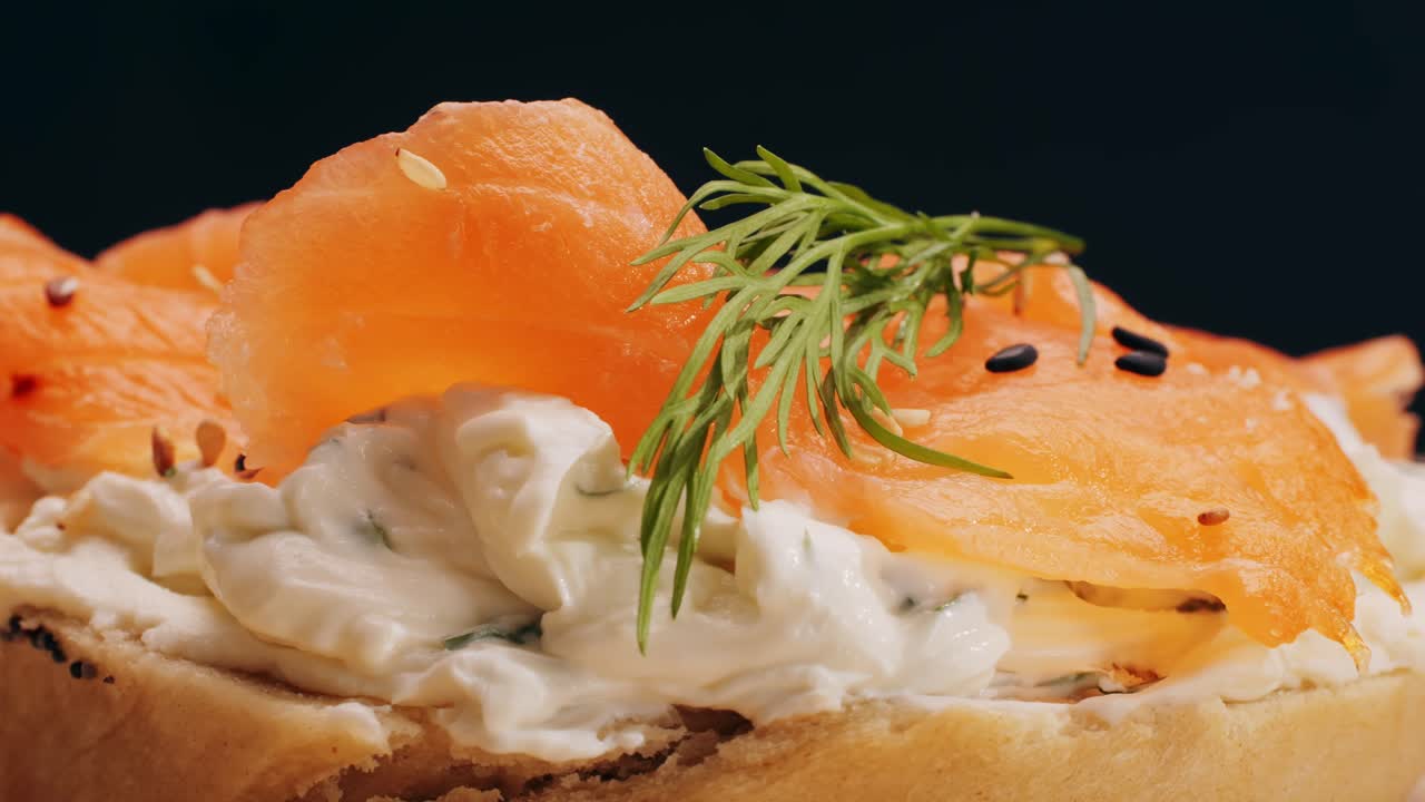 Bagel sandwich brunch, lunch plate of a bagel with smoked salmon and cream cheese and ham, close up morning cafe menu.