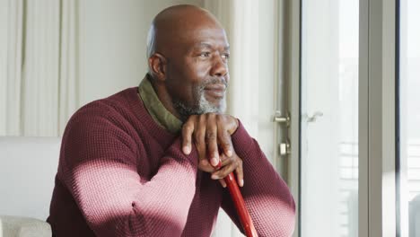 Video-of-lonely-thoughtful-senior-american-african-men-in-living-room