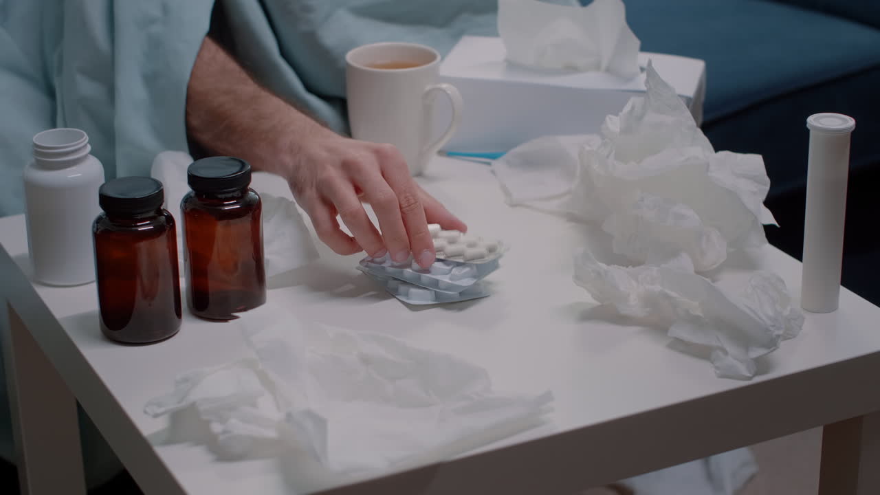 Close up of hand searching for capsule tablets against virus