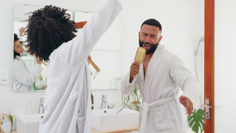 couple singing and dancing in a bathroom