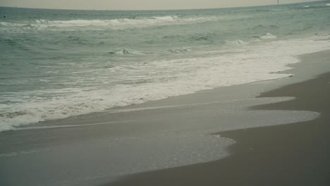 waves washing up on the beach in the winter