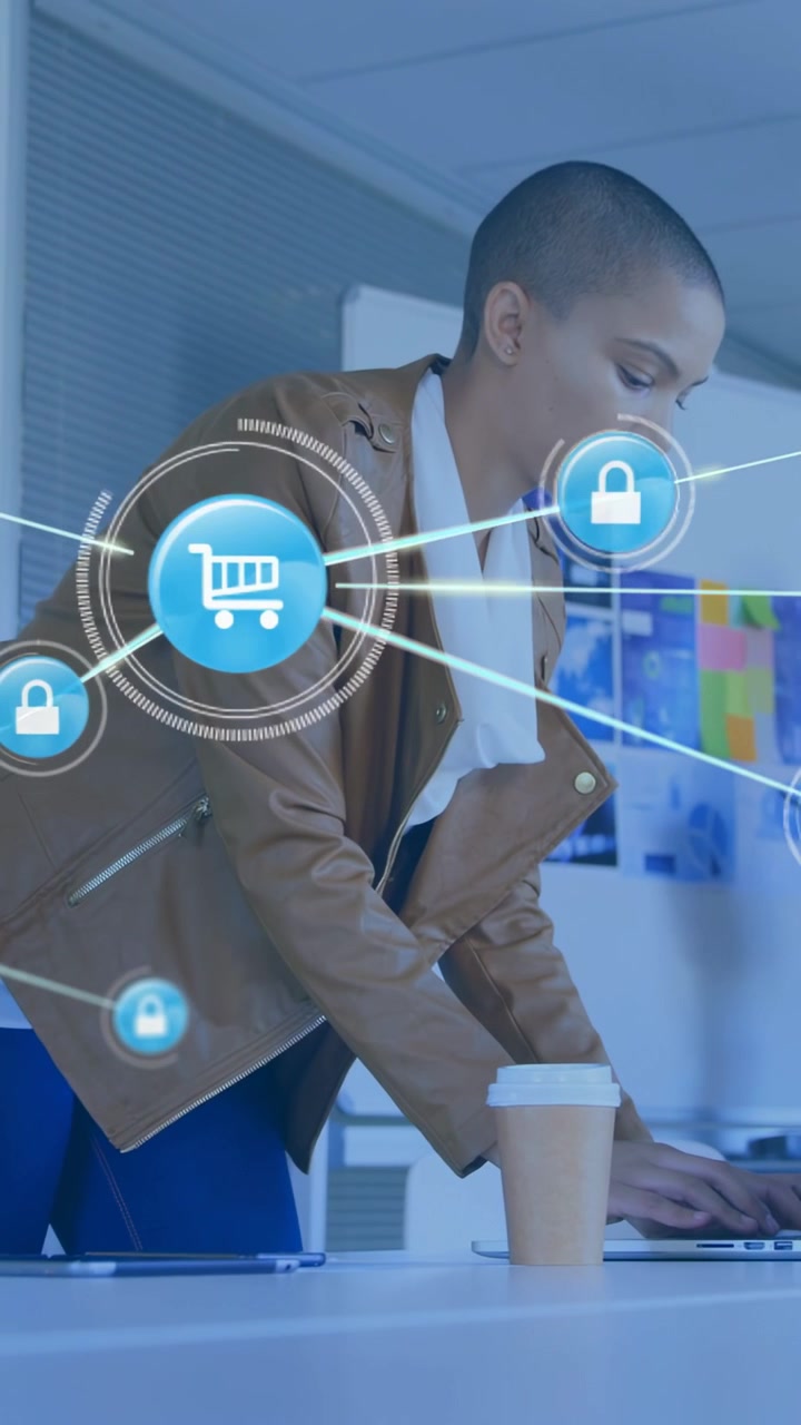 Vertical video: Woman leaning laptop, typing, launching IT overlay of cart and lock icons framing