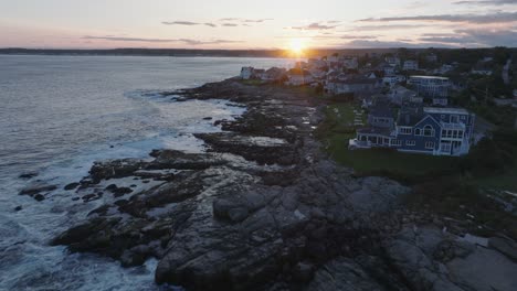 aerial drone shot of york beach maine flying over cape neddick nubble lighthouse into the sunset