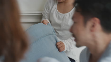 happy asian family with children jumping on bed playing with mother and father having fun on weekend morning excited little kids enjoying game with parents at home 4k footage