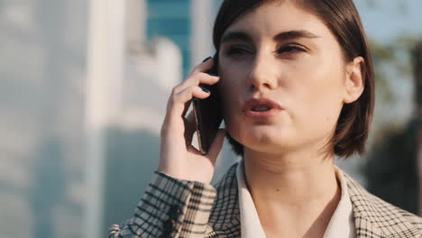 stylish woman making a business call outdoor.