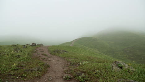 titling down shot of a path winding through the ridges of a mountainous region in lomas de manzano, pachacamac, lima, peru