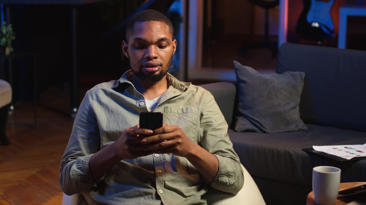 Vertical Video Young black guy texting his friends over social media ...