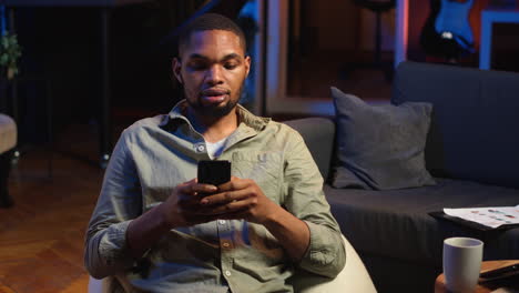 vertical video young black guy texting his friends over social media messaging apps