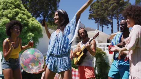 diverse group of friends having fun and dancing at a pool party