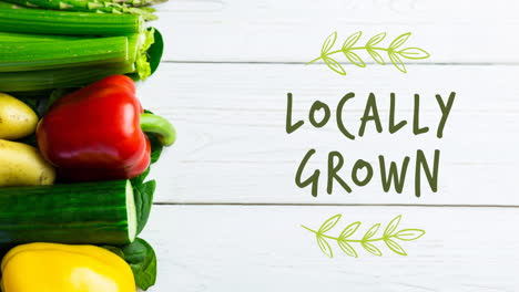 animation of locally grown text in green over fresh organic vegetables on wooden boards