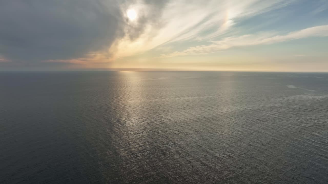 Seascape with Setting Sun - Sunset Behind Clouds Over the Ocean AERIAL