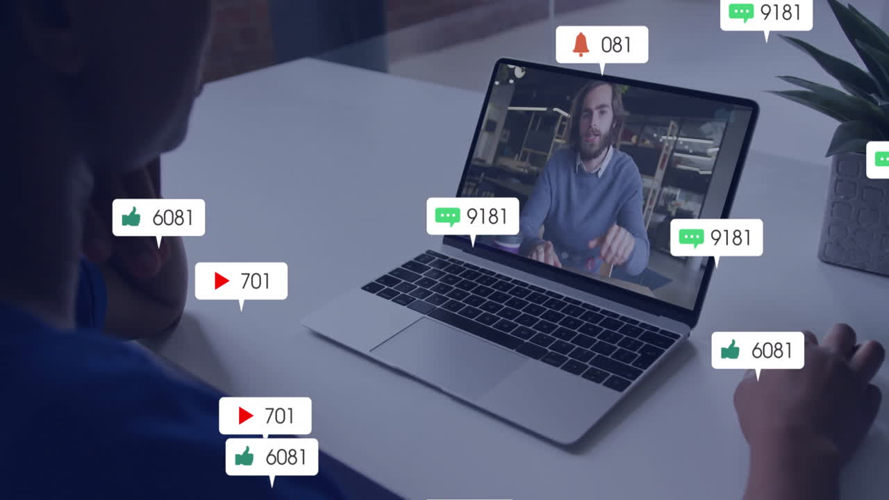 Watching animation video on laptop, person receiving social media notifications