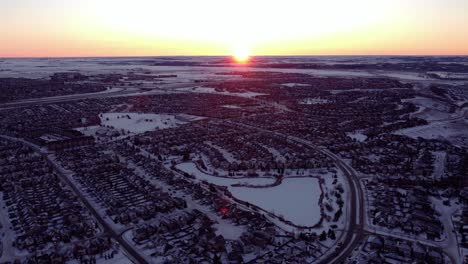 drone footage of calgary's houses during a beautiful winter sunrise