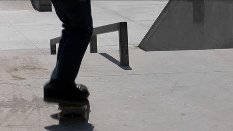 a skateboarder ollies onto a rail and grinds his way down