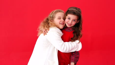 cute festive sisters exchanging gifts
