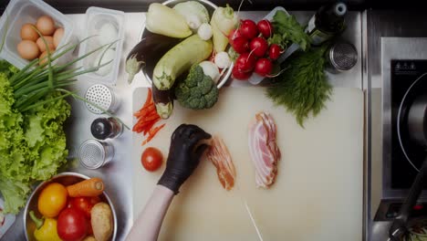 chef preparing bacon and vegetables