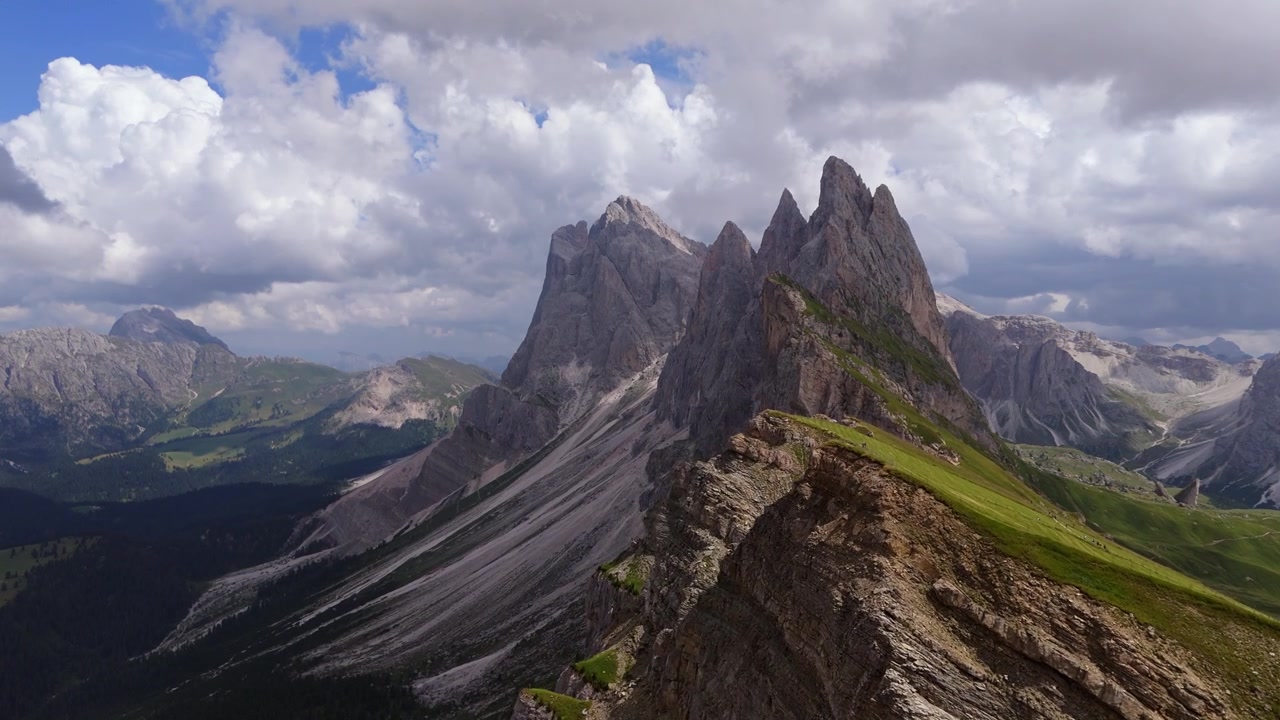 Smooth forward drone flight over the iconic Seceda ridge showcasing towering limestone peaks and alpine scenery.