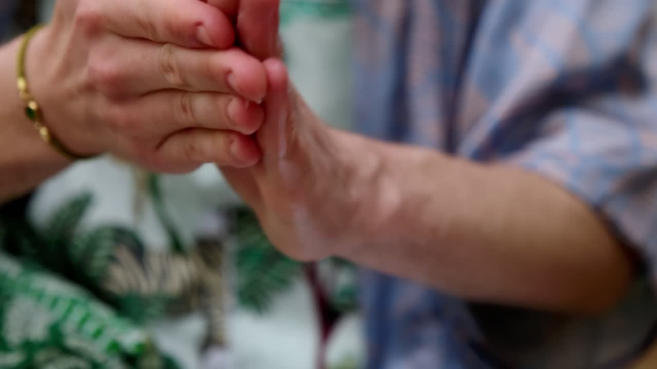 Close up of fingers pressing bottle for applying foam cream to hands, rubbing before applying to face. Health care.