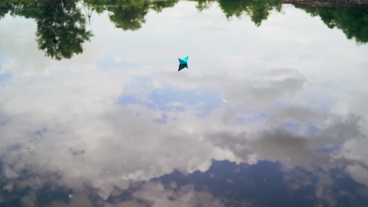 Paper boat on the river. Paper boat sailing along the river