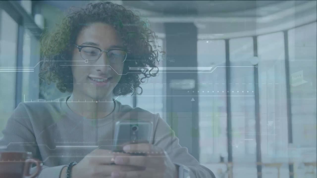 Animation of digital interface over smiling biracial young man with curly hair using mobile phone