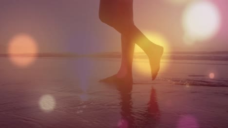 animation of light spots over caucasian woman at beach