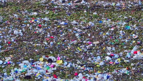 Ocean-waves-full-of-plastic-trash,-close-up-sea-pollution,-world-catastrophe