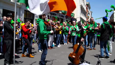 st. patrick's day parade with irish flag and street musicians