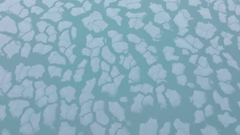 aerial view tilting over ice blocks, revealing the near north side of chicago, usa