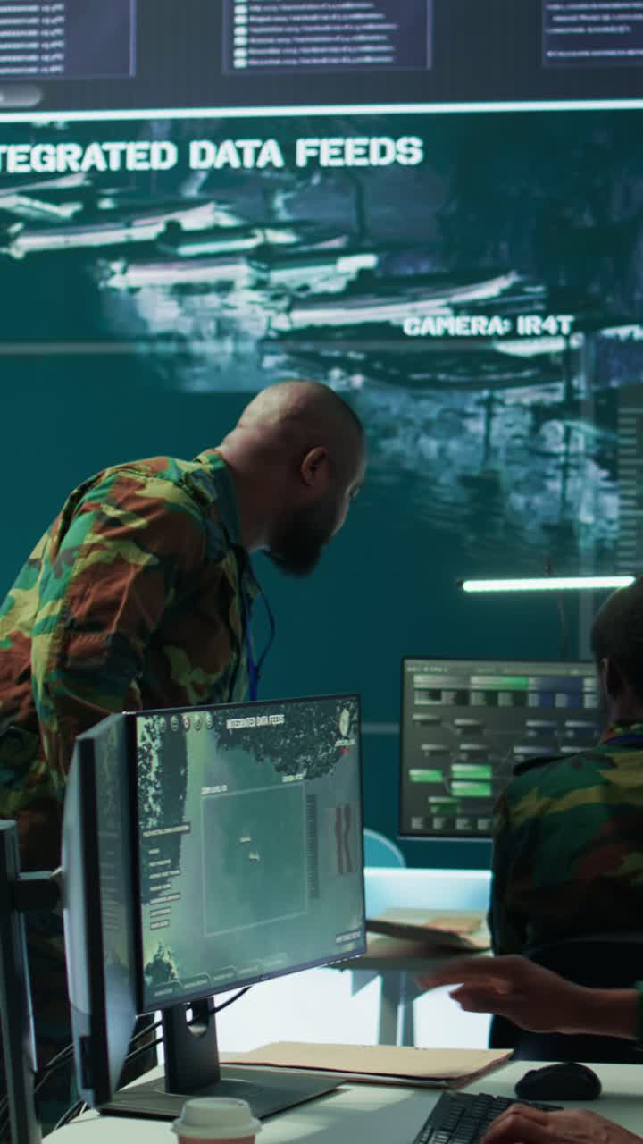 Vertical Video Military staff work in a high tech monitoring room command post