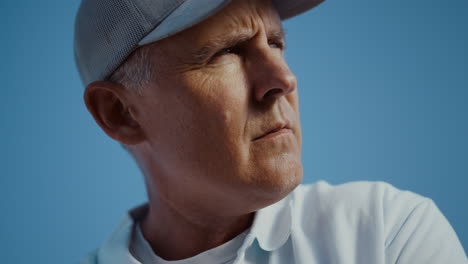 Golfing-man-face-looking-distance-outdoors.-Old-senior-wear-visor-cap-sportswear