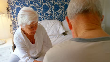 Caucasian-senior-couple-using-laptop-in-bedroom-at-home-4k