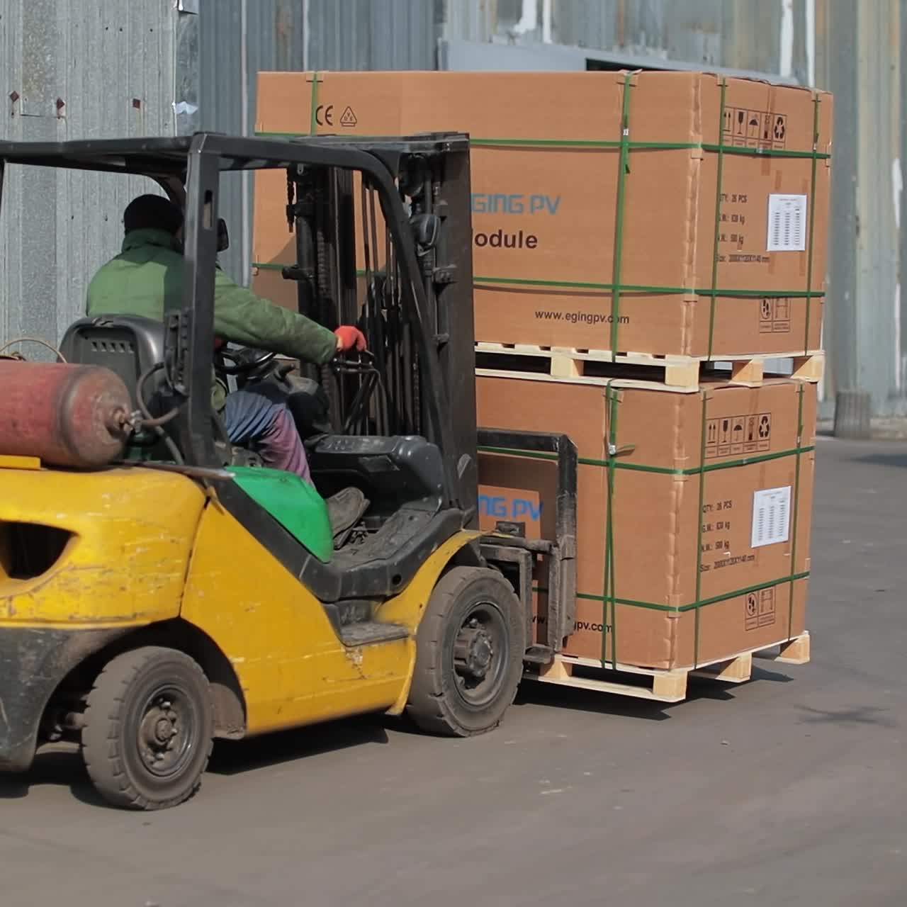 Man working with factory loader. Industrial professional forklift transportation