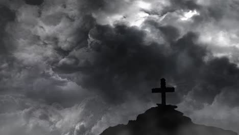 stone cross on a rocky hill silhouette