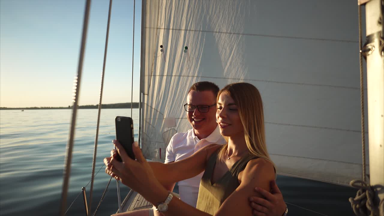Couple Taking a Selfie on a Sailing Boat at Sunset