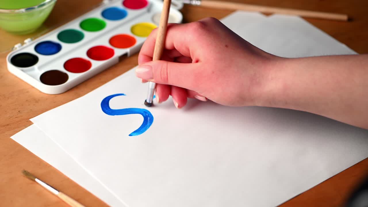 Woman draws words save life. Drawing ukrainian flag. Stop war concept. Patriotic concept. War in Ukraine.