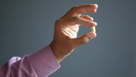 hand holding a pill