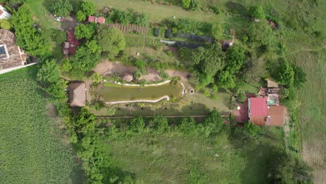 Aerial-perspective-of-rural-Oaxaca,-Mexico-with-natural-pond-and-green-terrain