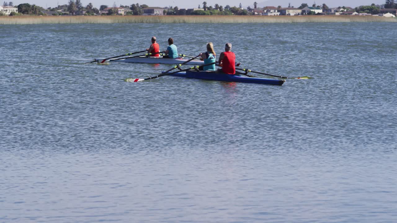 Four senior caucasian men and women rowing boat on a river