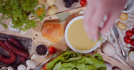 Soup-In-Bowl-Amidst-Various-Ingredients-Assorted-On-Wooden-Table-5