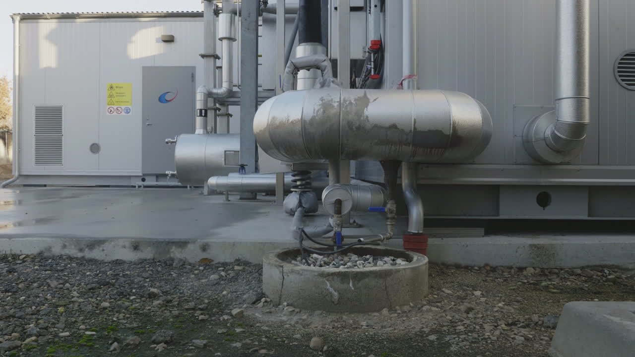 Detailed view of a modern biogas installation in rural Denmark, showing pipes, and clean energy infrastructure producing renewable gas from organic waste
