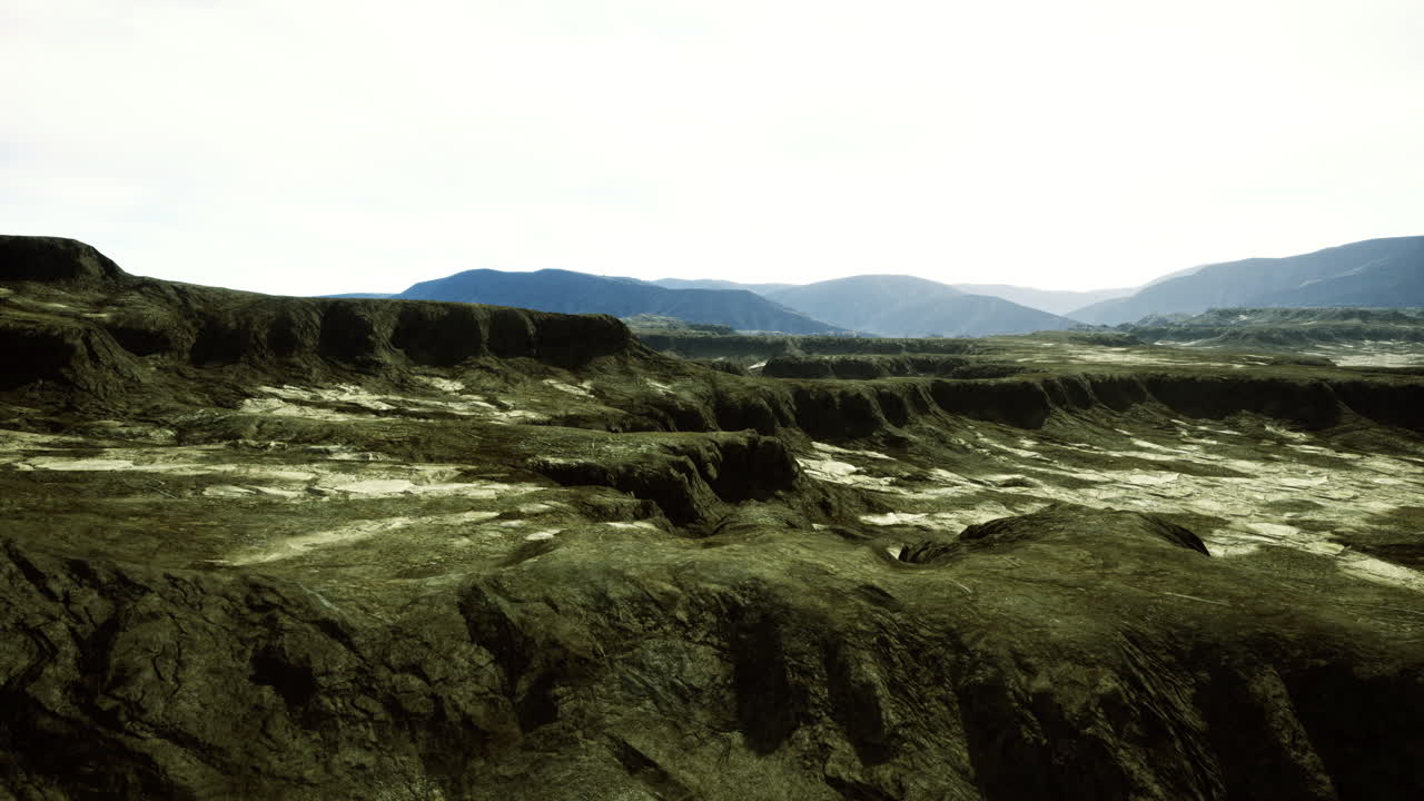 Landscape features rugged terrain under a bright sky in a remote area
