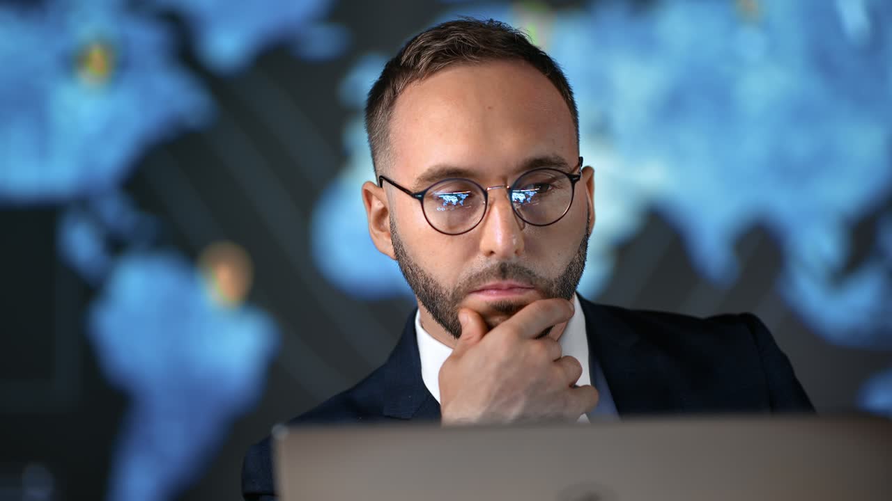 Business male in suit working laptop analyzing corporate stock exchange information hi tech office