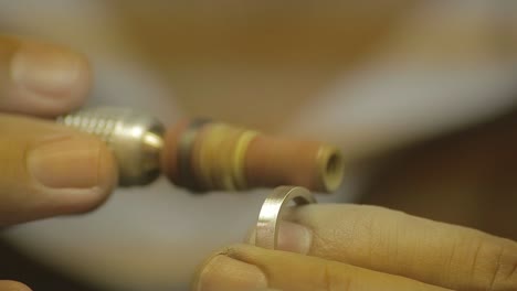 italian goldsmith at work building an engagement or a wedding ring