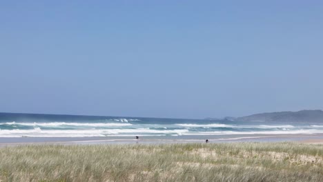 peaceful coastal scene with waves and distant hills