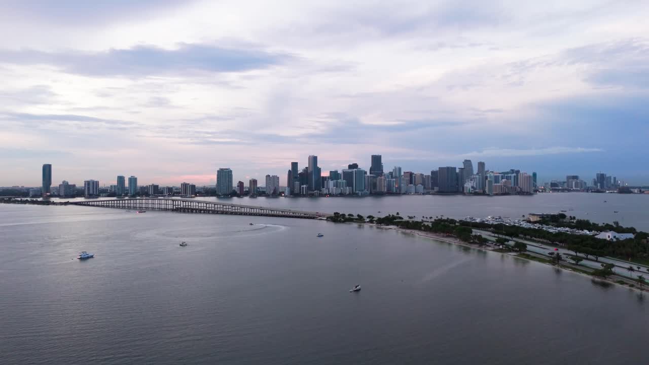 Drone shot of Miami and William M Powell bridge from Virginia Key at dusk